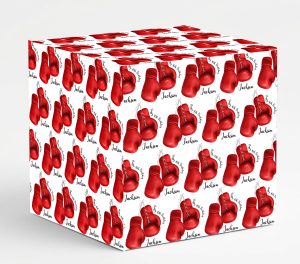 A square gift box wrapped in white paper featuring a repeating pattern of hanging red boxing gloves. Text integrated into the pattern reads Happy 40th Birthday alongside the personalised name Jackson.