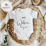 baby white vest with baby announcement on the front