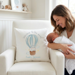 white cushion personalised for a baby with a hot air balloon on the front