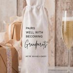A Personalised New Grandparents Wine Bottle Bag made of cream linen with black text saying Pairs Well With Becoming Grandparents We are Having A Baby.