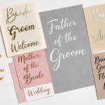 custom permanent vinyl decals for weddings, featuring personalised names precision-cut into various coloured vinyls, including metallic gold and bright pink, displayed on a clean white background.