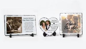 A display of three personalised natural rock photo slates in rectangle, heart, and square shapes, featuring custom wedding photos and romantic anniversary text, sitting on a wooden table.